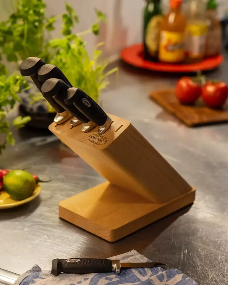 Marttiini kitchen knife set in a wooden block with stainless steel blades on a kitchen counter.