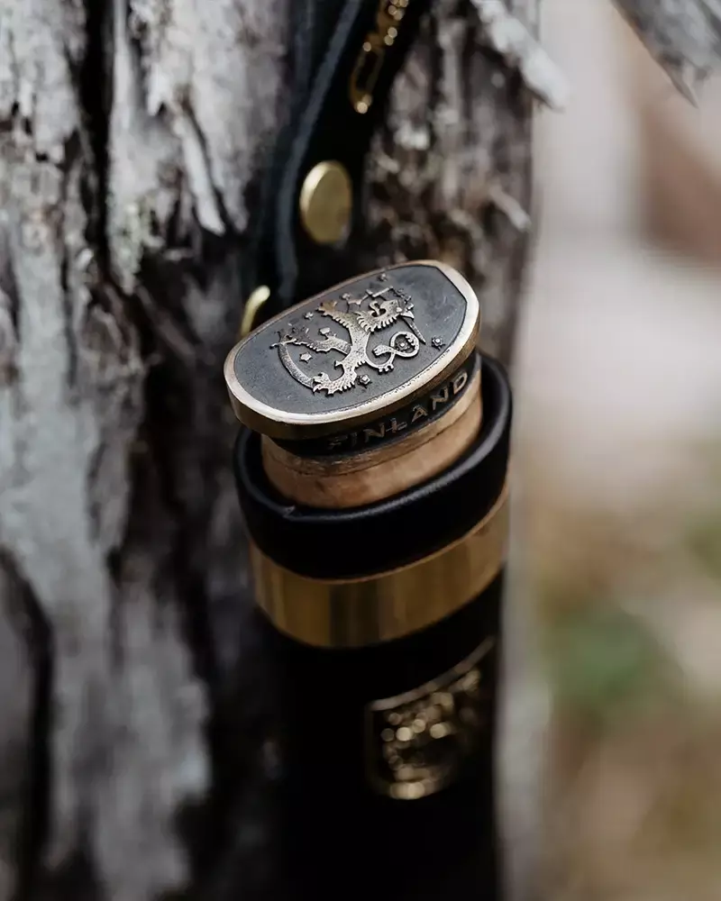 Close-up of a Marttiini knife featuring the Finnish lion emblem on the sheath and pommel.
