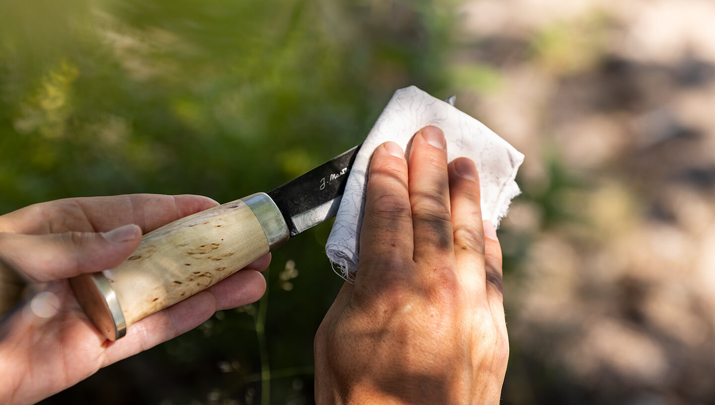 Ballistol Universal Oil bottle and knife sheath in hand
